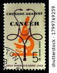 Small photo of USA - 1965: Crusade Against Cancer, 5 cent postage stamp featuring a microscope and stethoscope, on black background