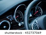 Luxury car interior details. Speedometer and steering wheel