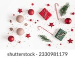 Christmas composition. Christmas gifts, red and golden decorations on white background. Flat lay, top view