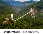 Small photo of Bach Long Glass Bridge in Moc Chau District, Son La Province, Vietnam - May 6, 2022: Bach Long Bridge has a total length of 632 m, This is the world's longest pedestrian glass bridge in Moc Chau, VN