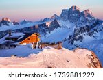 Rifugio Lagazuoi and Cable car station against the background of the Dolomites at sunset. Winter Alps near Cortina d'Ampezzo, Veneto, Italy. Postcard, Falzarego Pass, Dolomiti. Famous observation deck