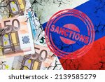 Euro bills, and a cracked Russian flag. Sanction stamp. The concept of sanctions against Russia. Finance. Business.