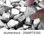 Small photo of Miners hold in their hands platinum or silver or rare earth minerals found in the mine for inspection and consideration