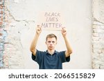 Small photo of Poster that says black life matters in the hands of a young man. Caucasian guy staged a protest demonstration against racism, wrote a slogan on cardboard