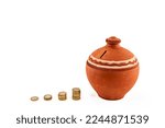 Small photo of Stacked coins or money Clay pot jug money box, penny or piggy bank. Saving and Clay pot jug money box. Saving money coin for healthcare, new house home, future, school, college, holiday.