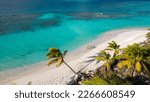 Small photo of shoal bay east, Anguilla. Couple walking on the beach. Beautiful beach with turquoise sea. Crystalline waters of white sand, with plenty of shade from coconut trees. The best beach in the Caribbean.