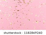 Golden sparkles on pink pastel trendy background. Festive backdrop for your projects.