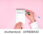 To do list in spiral notepad. Trendy pink background, flat lay style.