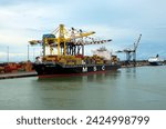 Small photo of Livorno, Italy-November 01,2023:Container terminal with stowed containers from different shippers gantry cranes and straddle carriers in Livorno. Import, export and business logistic.