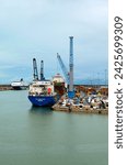 Small photo of Livorno, Italy-November 01,2023:Container terminal with stowed containers from different shippers gantry cranes and straddle carriers in Livorno. Import, export and business logistic.