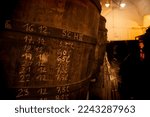 Small photo of manual annotation on wooden barrels of beer in the fermentation process in a historic brewery