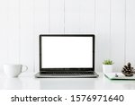 Small photo of Digital technology Laptop muck up blank white screen and flower pot book on white table ,Home interior or office background