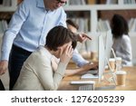 Small photo of Stressed employee intern suffering from gender discrimination or unfair criticism of angry male boss shouting scolding firing female worker for bad work, computer mistake or incompetence in office