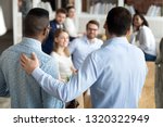 New mixed race employee having first working day in company standing in front of colleagues, executive manager employer introducing welcoming newcomer to workmates. Human resources employment concept