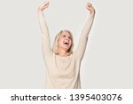 Excited senior woman raised stretched hands open mouth laughing screaming with joy feels happy isolated on grey studio background, weekend no stress euphoric lucky lady celebrating lottery win concept