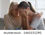 Small photo of Worried aged mother embracing comforting grown up daughter with broken heart family sit on sofa, elderly mom soothe crying adult child, divorce or miscarriage, share problem with someone close concept