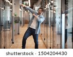 Small photo of Overjoyed funny male employee have fun perform winner dance in modern office hallway, excited happy millennial businessman celebrate business success or promotion, Friday evening, end of working week