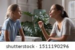 Small photo of Caring young mom sit at home study with daughter stutter pronounce sounds, loving mother parent speak teach impaired disabled child, do exercises practice voice pronunciation and articulation together