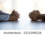 Close up clasped female hands of two businesswomen negotiate at table, confrontation concept, negotiators conflict, employees struggle for leadership at work, difficult job interview, hiring decision