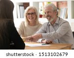 Small photo of People sit at desk in office focus on aged couple handshaking with female realtor real estate agent succeed agreement, after sign contract client express gratitude shake hands, successful deal concept