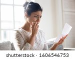 Small photo of Worried indian millennial girl read post correspondence thinking about unpleasant news in mail, anxious thoughtful young woman consider bad message in postal letter, get eviction or dismissal notice