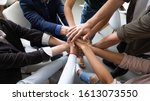 Small photo of Top close up lot of hands stacked together as symbol concept of teambuilding, loyalty, amity and warm relations between office workers seminar participants, business success celebration, start of work