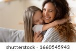 Small photo of Cute little girl hug cuddle excited young mum show love and affection, smiling mother and funny small preschooler daughter have fun at home embrace sharing close tender moment together