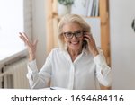 Happy smiling 60 years old businesswoman talking on phone, making business call close up. Employee chatting with friend during break, manager consulting client customer by cellphone.