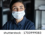 Small photo of Hopeful smiling young woman in protective face mask look in distance hope for coronavirus pandemic end, happy millennial female in medical facial cover from COVID-19 thinking, healthcare concept
