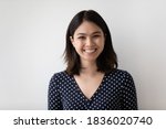 Small photo of Profile picture of smiling millennial asian girl isolated on grey wall background look at camera posing. Headshot portrait of happy young Vietnamese woman renter or tenant satisfied with service.