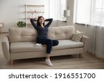Small photo of Young serene asian woman rest on soft stylish couch after finishing household chores enjoy tranquility feeling satisfied. Peaceful vietnamese lady chill at modern studio apartment breath fresh air nap