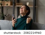 Small photo of Great thing. Overjoyed emotional young latina female looking up screaming yes seeing perfect news on mobile phone screen. Joyful millennial woman laugh celebrate success winning money prize in lottery
