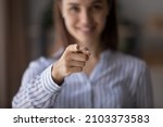 Small photo of Happy blurred young woman pointing index finger at camera, smiling. Businesswoman, employer, HR manager choosing you. We need you, human resource, hiring, employment concept. Close up of hand