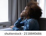 Small photo of Desperate depressed crying teenage Black girl side candid portrait. Stressed teenager thinking over problems, difficulties, offence, suffering from depression, anxiety, emotional disorder