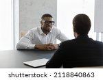 Small photo of Happy confident African business leader meeting with employee, partner, discussing project. Employer interviewing job candidate. Client consulting lawyer, financial broker, banker for advice