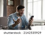 Small photo of Excited smartphone user man staring at screen in surprise, reading text message getting good news, rejoicing at success, luck, happy opportunity, winning prize, gasping in shock, laughing, smiling