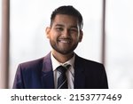 Happy young millennial Indian businessman in formal suit head shot portrait. Confident ambitious CEO, executive, startup leader, manager looking at camera, smiling. Business leadership concept