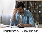 Small photo of Financial problem. Concerned millennial businessman calculate taxes bills payments deal with debt bankruptcy overdue account. Worried young man accountant unable to form balance sheet look for mistake