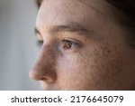 Small photo of Side profile view face of freckled serious pensive woman staring aside. Close up cropped image of thoughtful young 18s female looking into distance. Concept of vision care, eyesight check up in clinic