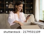 Happy woman unbox parcel box, check ordered items in phone use retail ecommerce application, leave positive feedback to customer, feel satisfied with delivered goods, quick delivery services concept