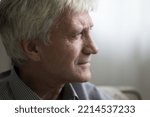 Close up profile view face of sad senior man staring into distance looking pensive, deep in thoughts and life troubles. Baby boomer generation person portrait, loneliness in older age, nostalgia