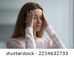 Small photo of Young woman suffers from intense headache, touch temples try relieving painful feelings with eyes closed, feels badly due to stressful situation, hurt, emotional concerns, physical malaise or migraine