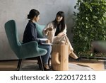 Small photo of 50s businesswoman talks to intern sit on armchairs in office, experienced mentor gives professional advices to apprentice, boss make assignments to secretary, subordinate listen to chief, writes tasks