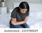 Small photo of Frustrated unhappy girl feeling belly ache, strong stomach pain, suffering from indigestion, gastritis, digestive problems, chronic inflammation or painful period symptoms. Stomachache concept
