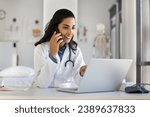 Small photo of Young doctor woman talking to patient on mobile phone, smiling, using laptop at workplace, telling healthcare checkup test results, bringing good news, using modern technology for communication