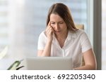 Small photo of Shortsighted businesswoman squinting eyes looking at pc laptop screen while sitting at home office, tired of computer thoughtful woman having poor weak eyesight, bad sight, blurry vision, need glasses