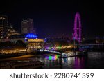 Small photo of LONDON - November 12, 2022: London Eye and Royal Festival Hall come alive at night with colorful illumination, adding to the magical ambiance of the city skyline.