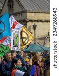 Small photo of LONDON - April 22, 2023: Eloquent activism: Extinction Rebellion flags and protest signs soar above the London march, visually articulating the demand for climate action.