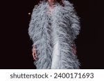 Small photo of Haute couture gray ostrich feather coat. Fashion details on black background