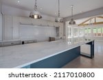 Small photo of Sible Hedingham, Essex - May 10 2017: Kitchen area in period style within refitted and restored 16th century home with range of units including peninsular marble top island